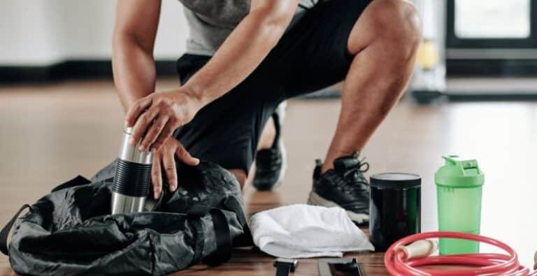 A man unpacking his crossfit bag in the gym