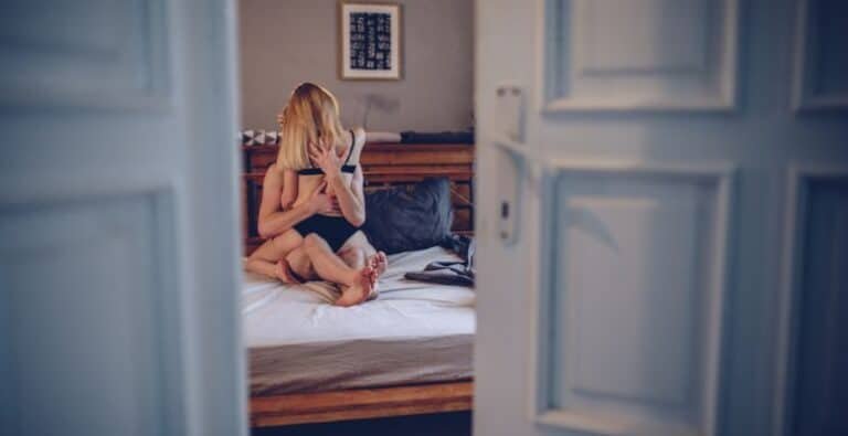 Couple embracing in bed, suggesting intimacy